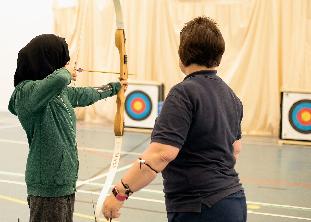 Archer being coached on a course